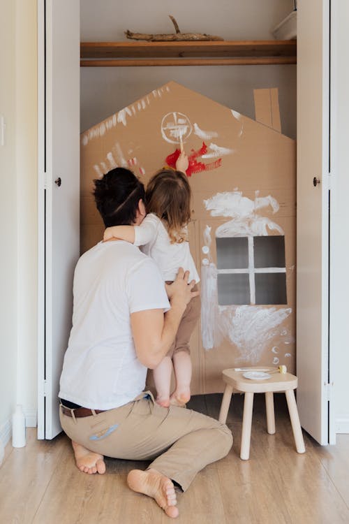 Photo Of Man Carrying Child