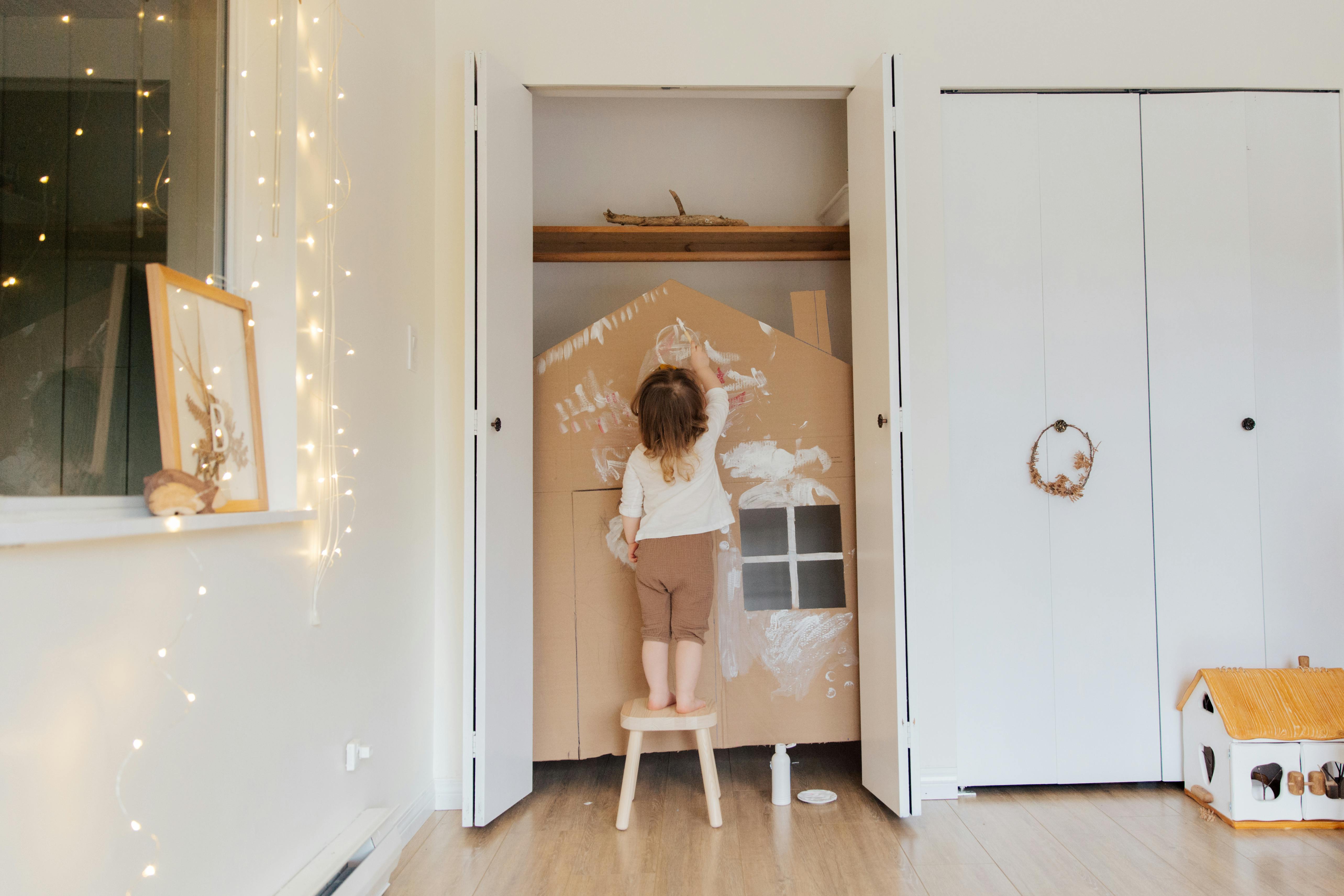 photo of child standing on stool