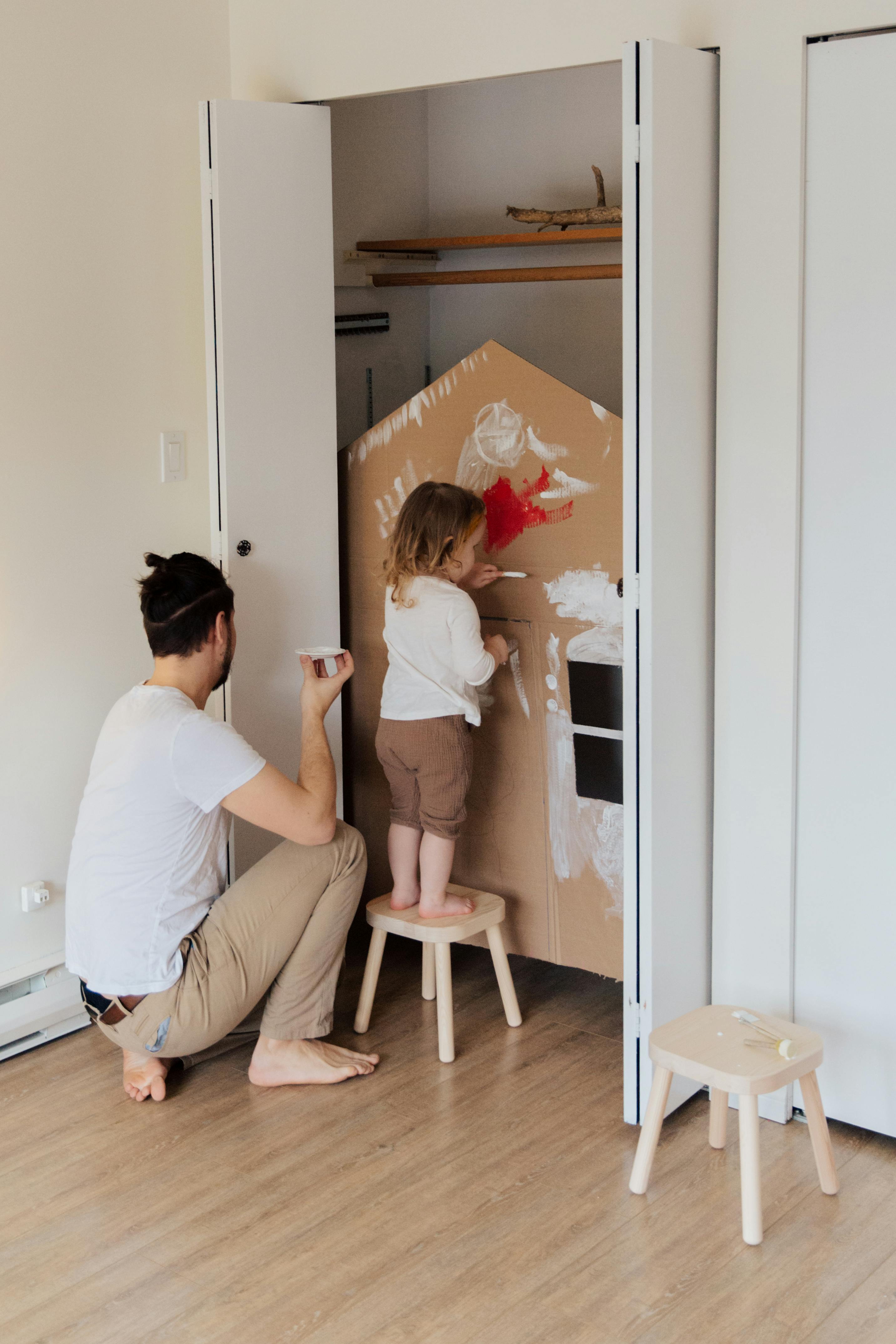 photo of kid standing on stool