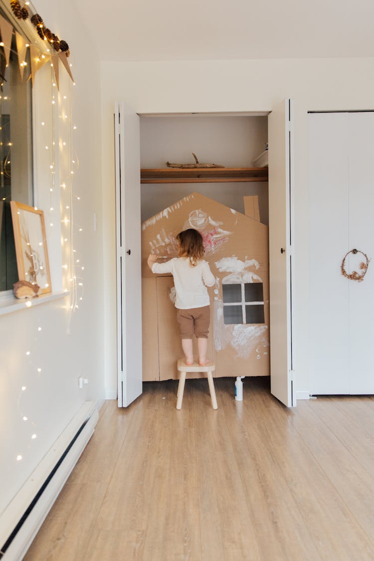 Photo Of Child Standing On Wooden Stool