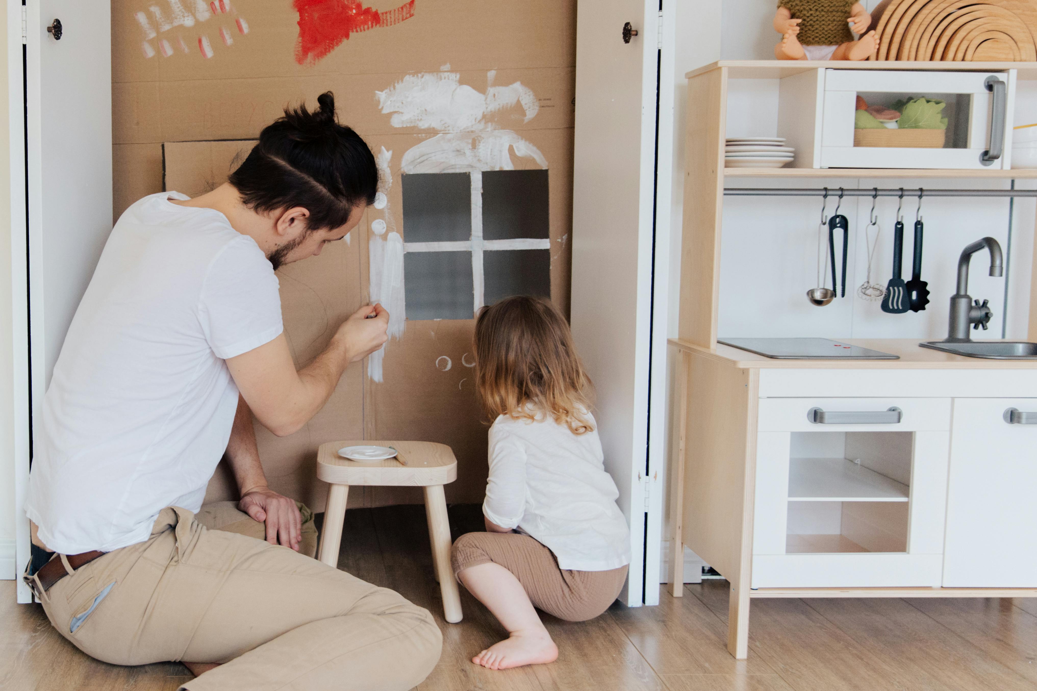 photo of man painting cardboard