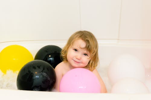 Photo Of Child Surrounded By Balloons