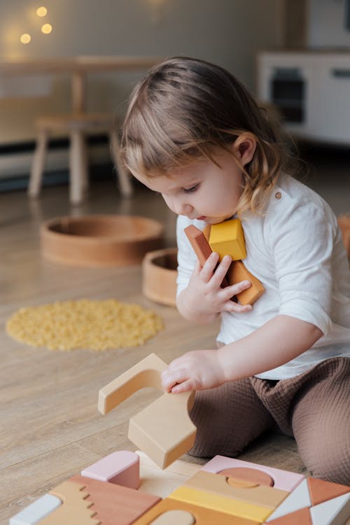 Free Photo Of Child Holding Wooden Blocks Stock Photo