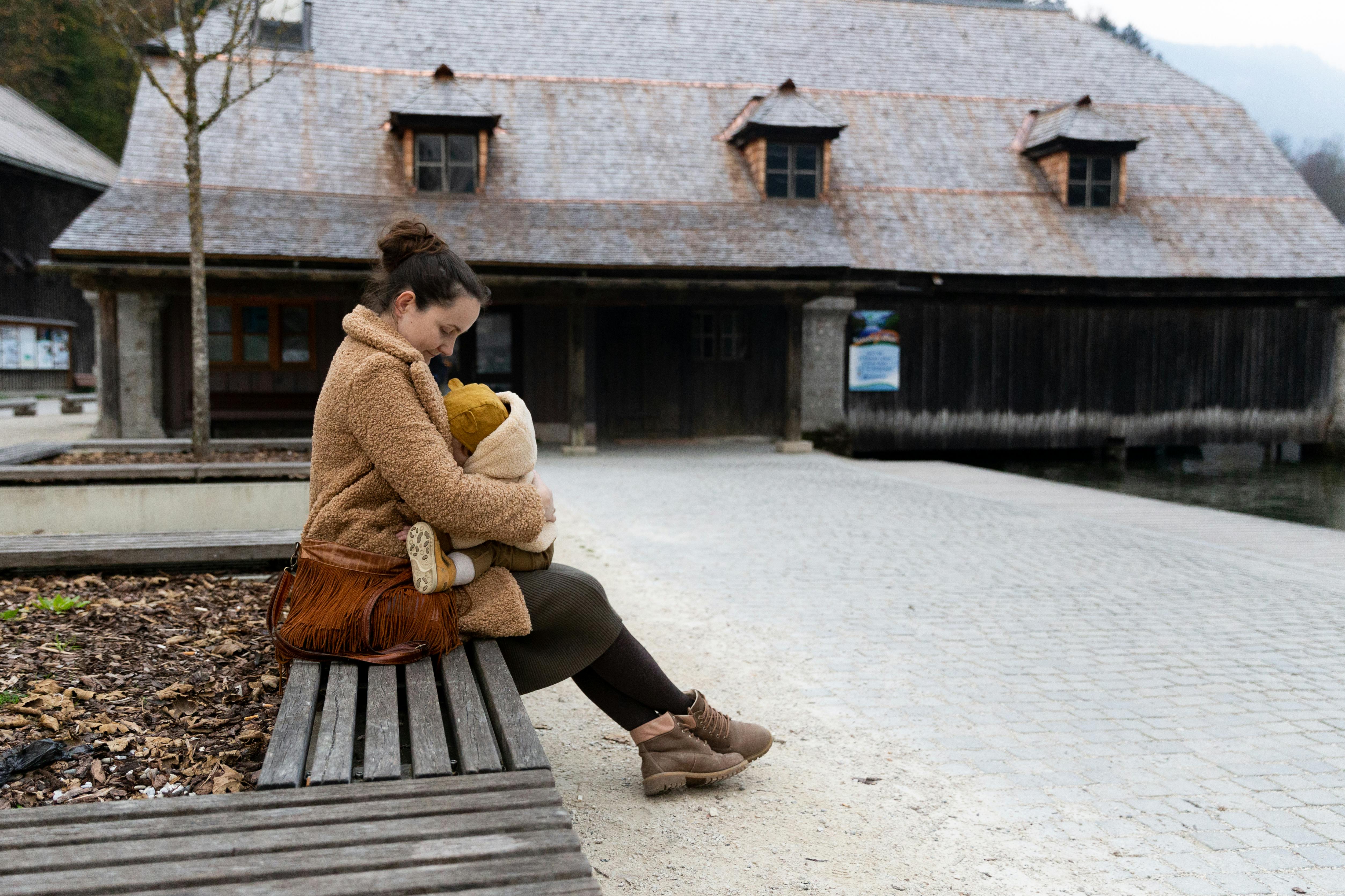 photo of woman holding baby