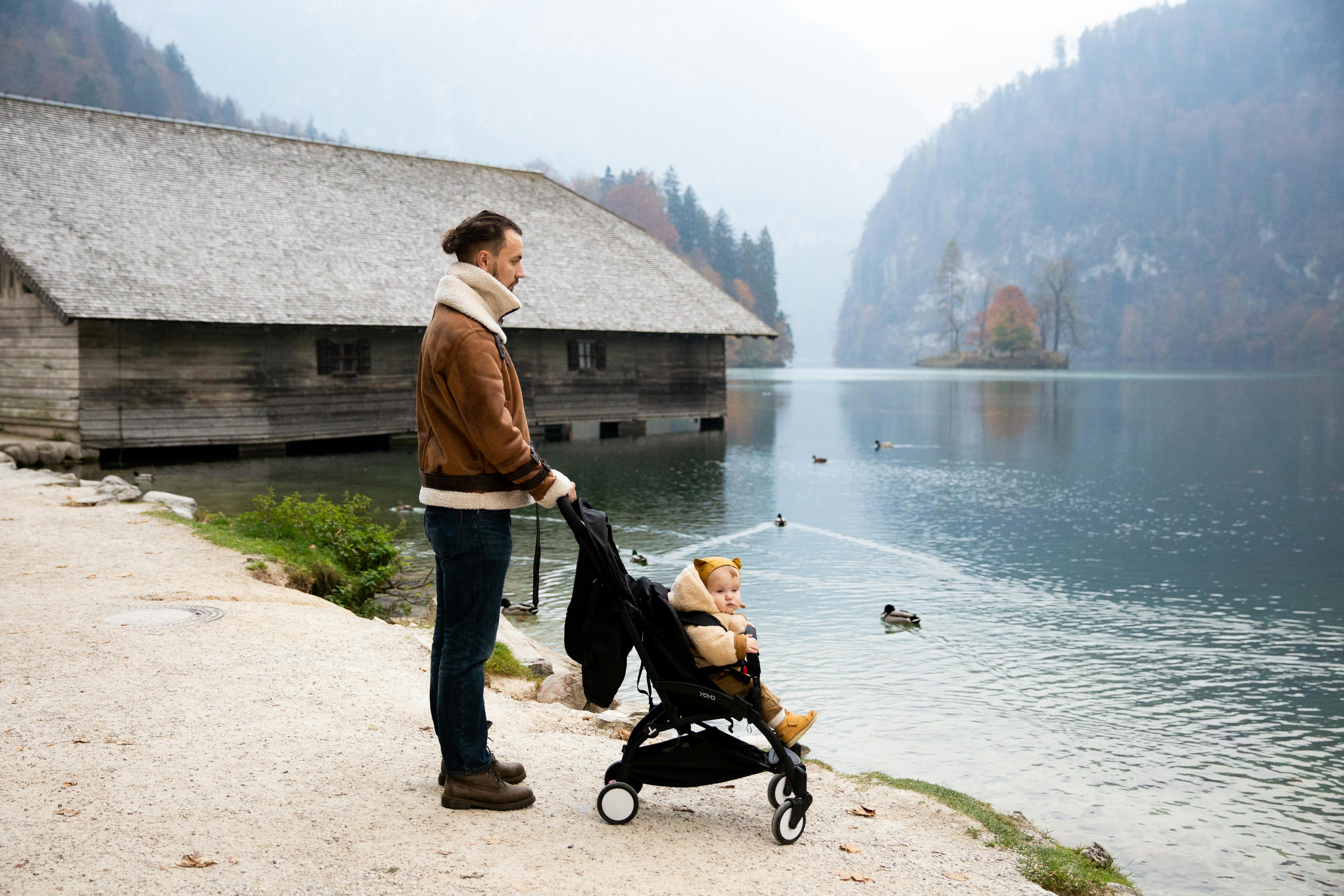 photo of man holding stroller