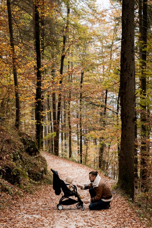 Photo Of Man And Baby On forest 