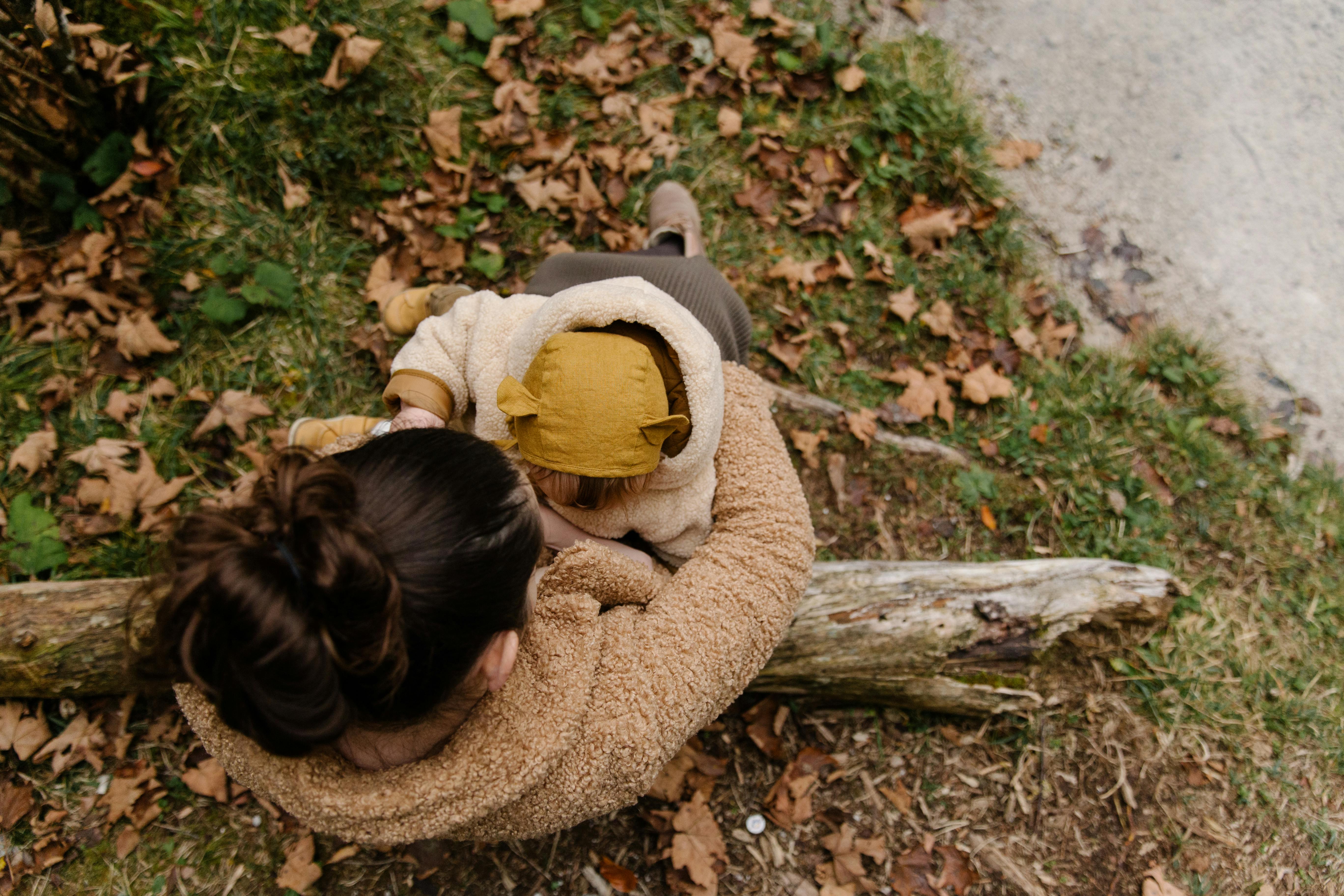 photo of woman holding baby