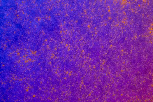 Dynamic macro shot of a colorful cellular pattern with vivid purple and orange hues.