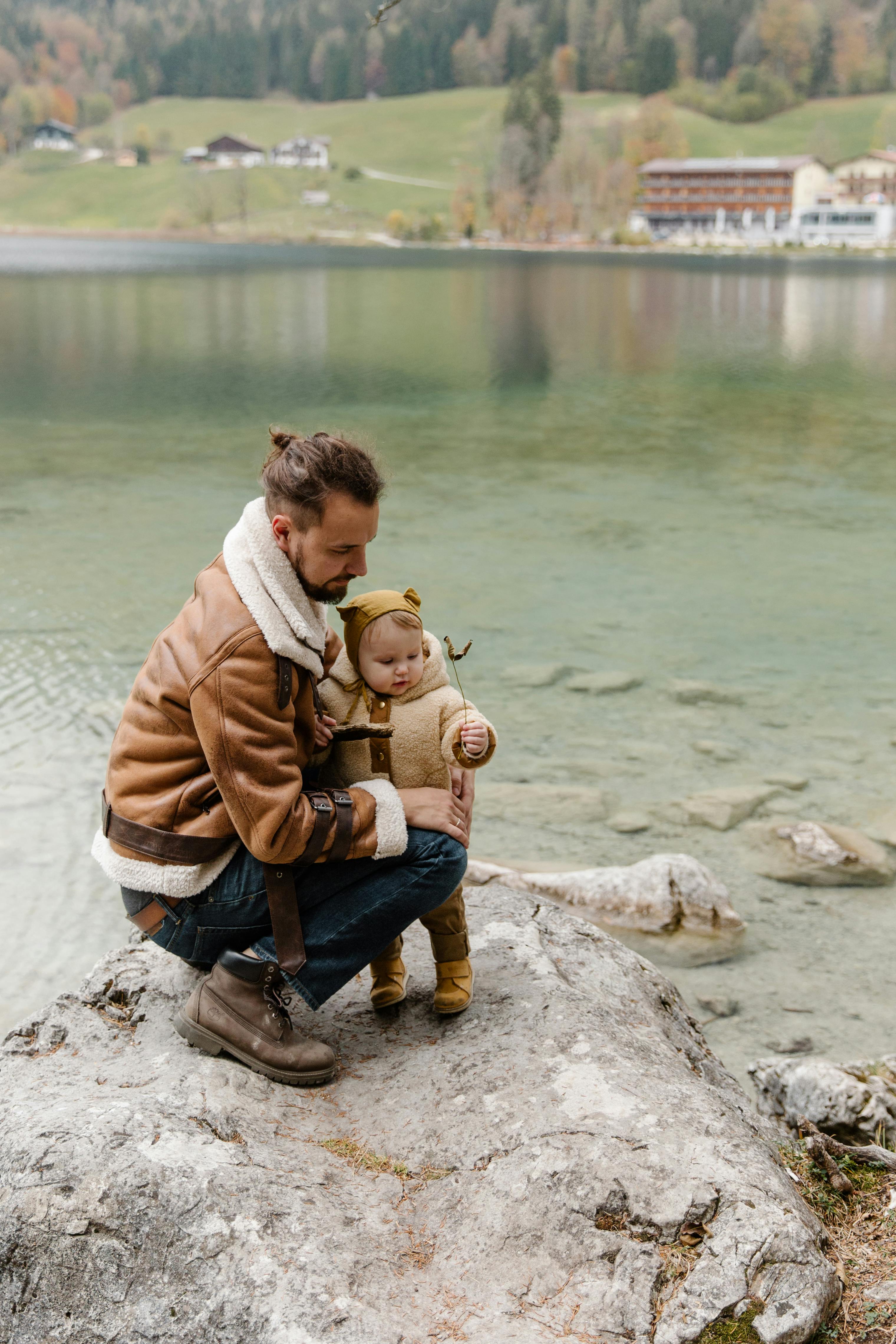 photo of man holding baby