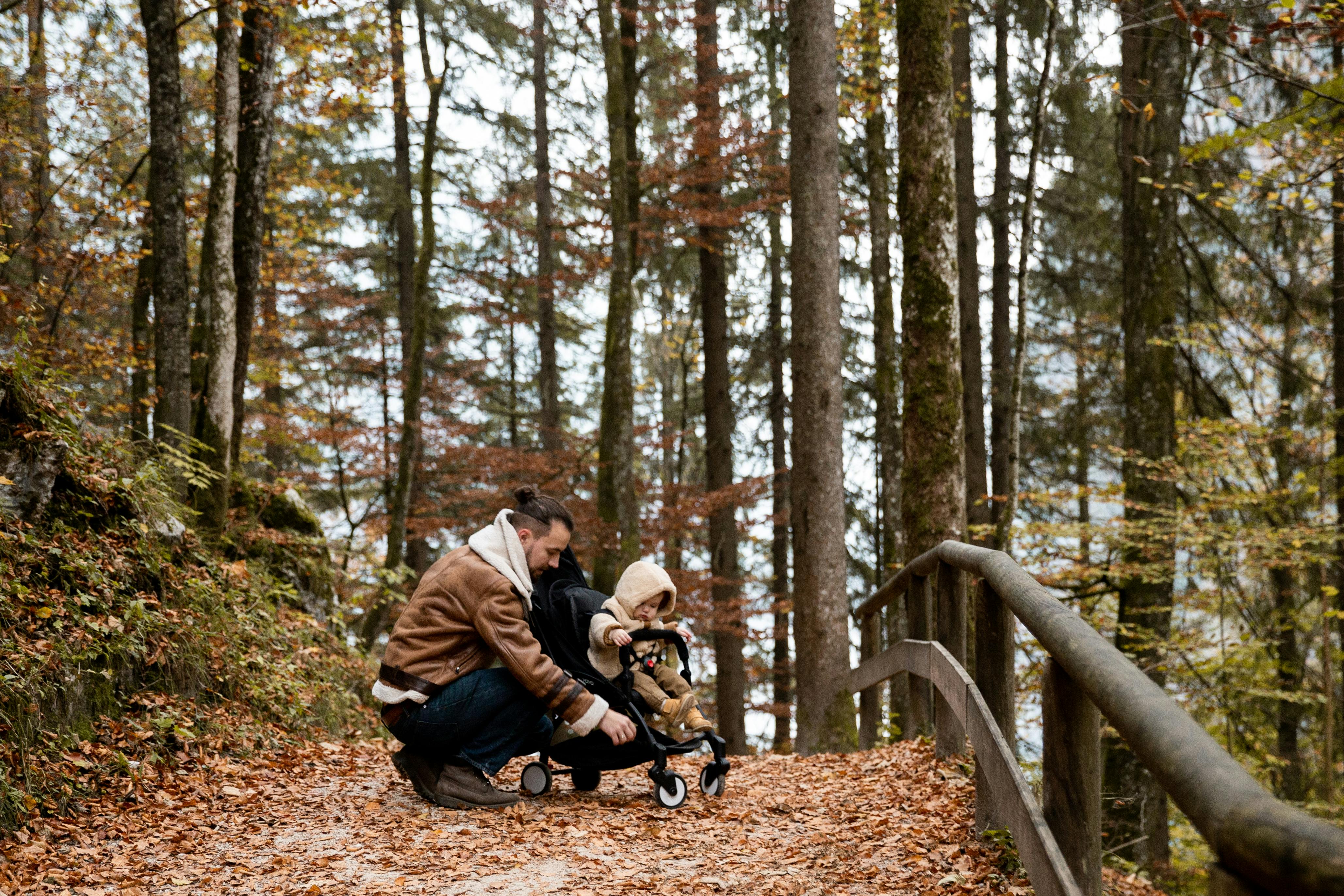 photo of man holding stroller