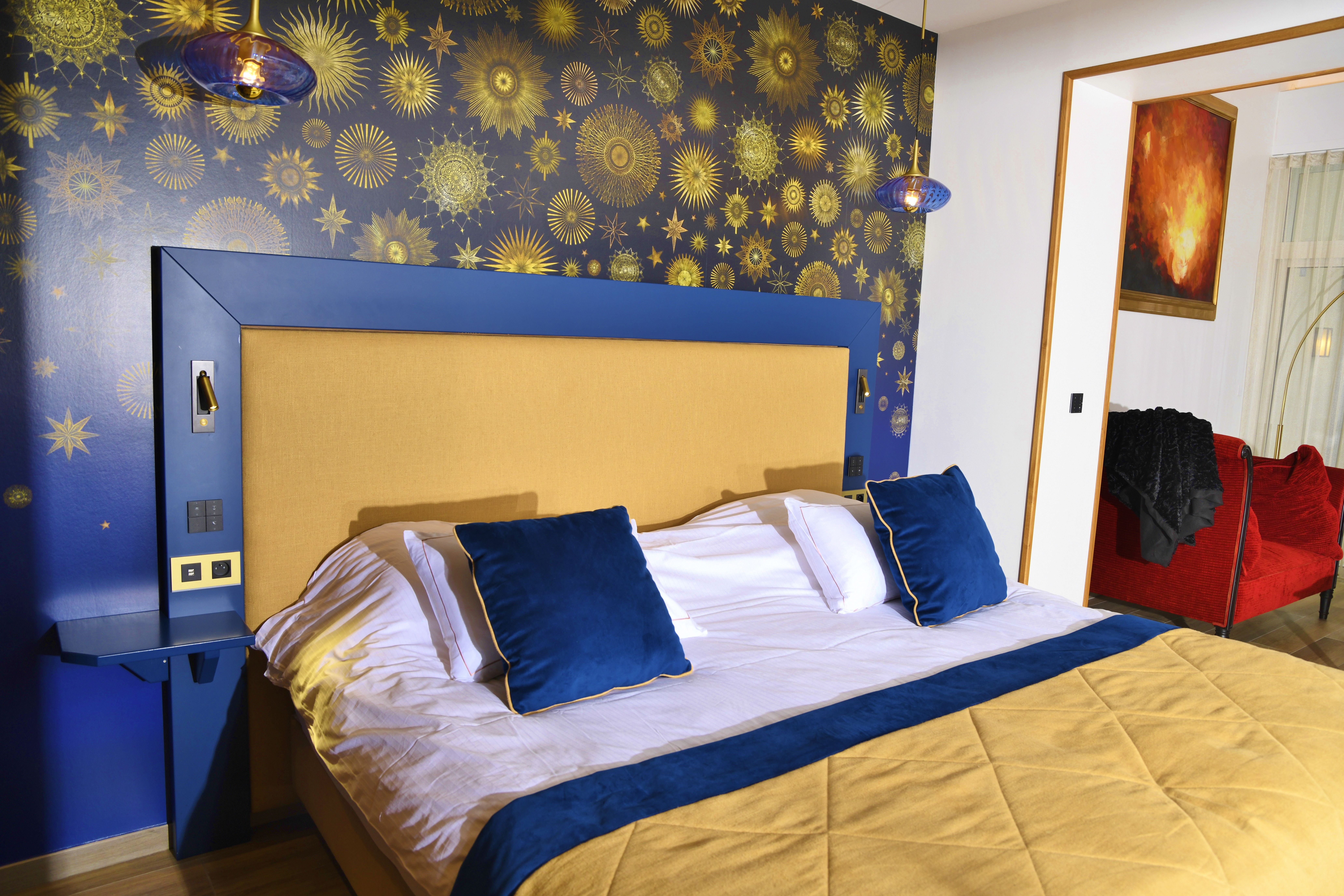 Luxurious bedroom featuring star-themed wallpaper and stylish design elements.