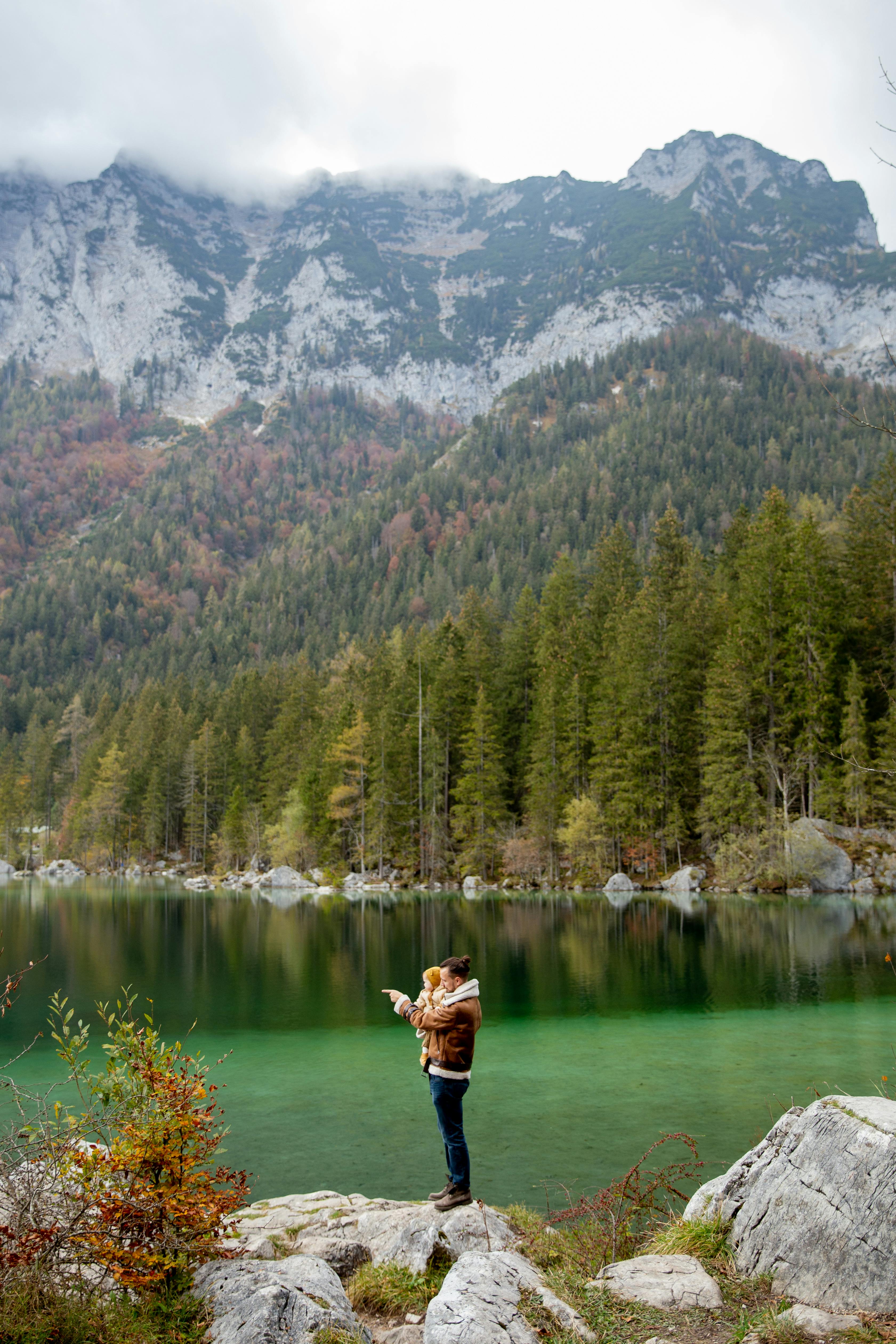 photo of man carrying baby