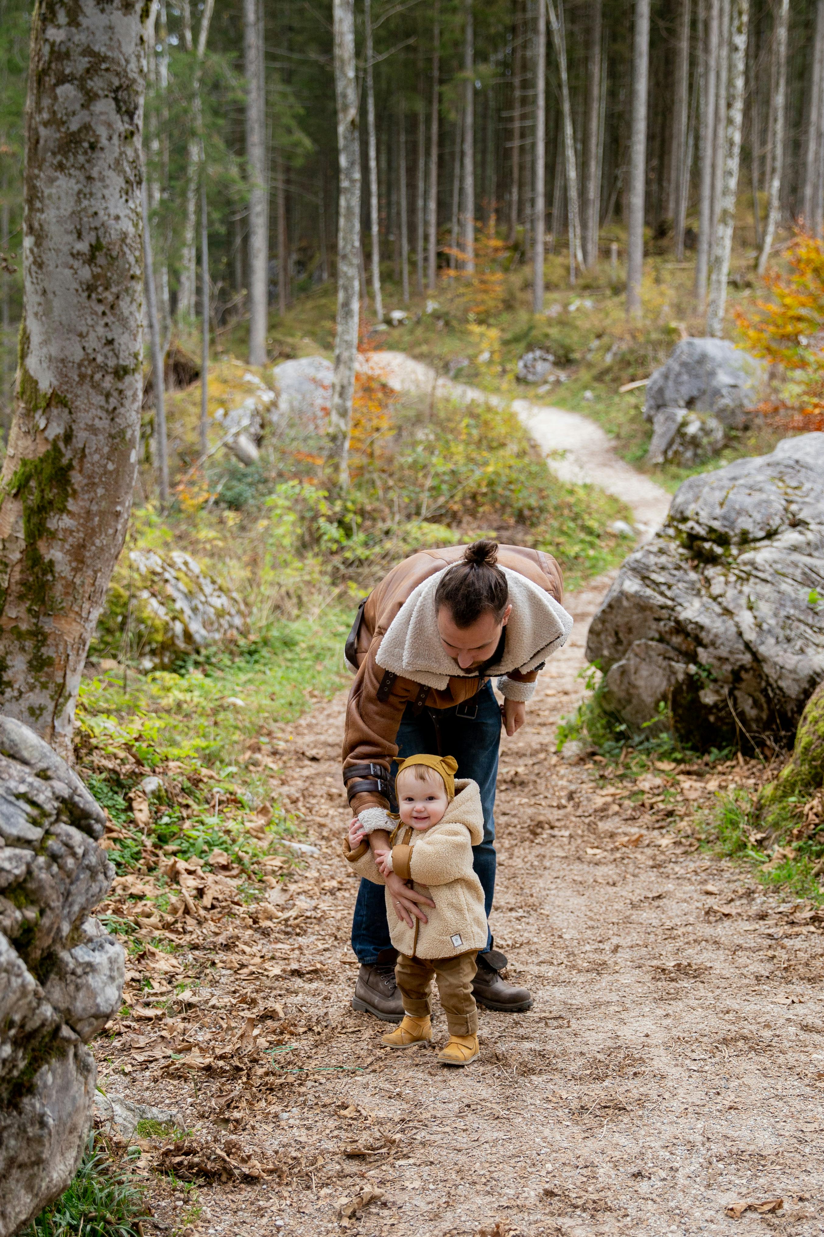 photo of man holding baby