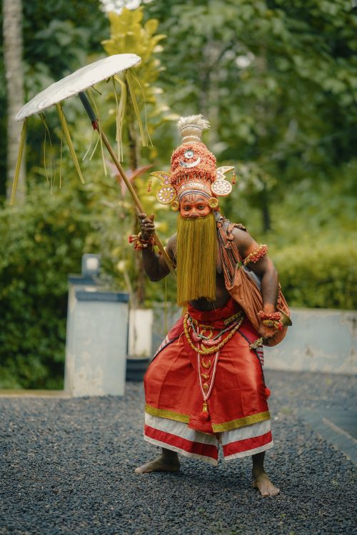 Free Vibrant Theyyam performer with traditional attire and makeup in Kozhikode, Kerala, India. Stock Photo