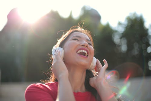 Woman in Red Crew Neck Shirt with Headphones