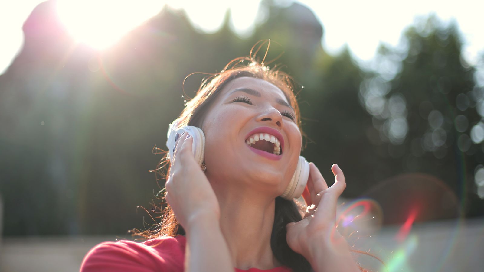 Smiling woman listening with headphones