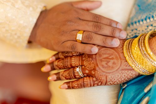 Free Close-up of South Asian bridal henna with gold jewelry and matching rings, showcasing cultural elegance. Stock Photo
