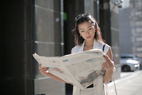 Free Photo Of Woman Holding Newspaper Stock Photo
