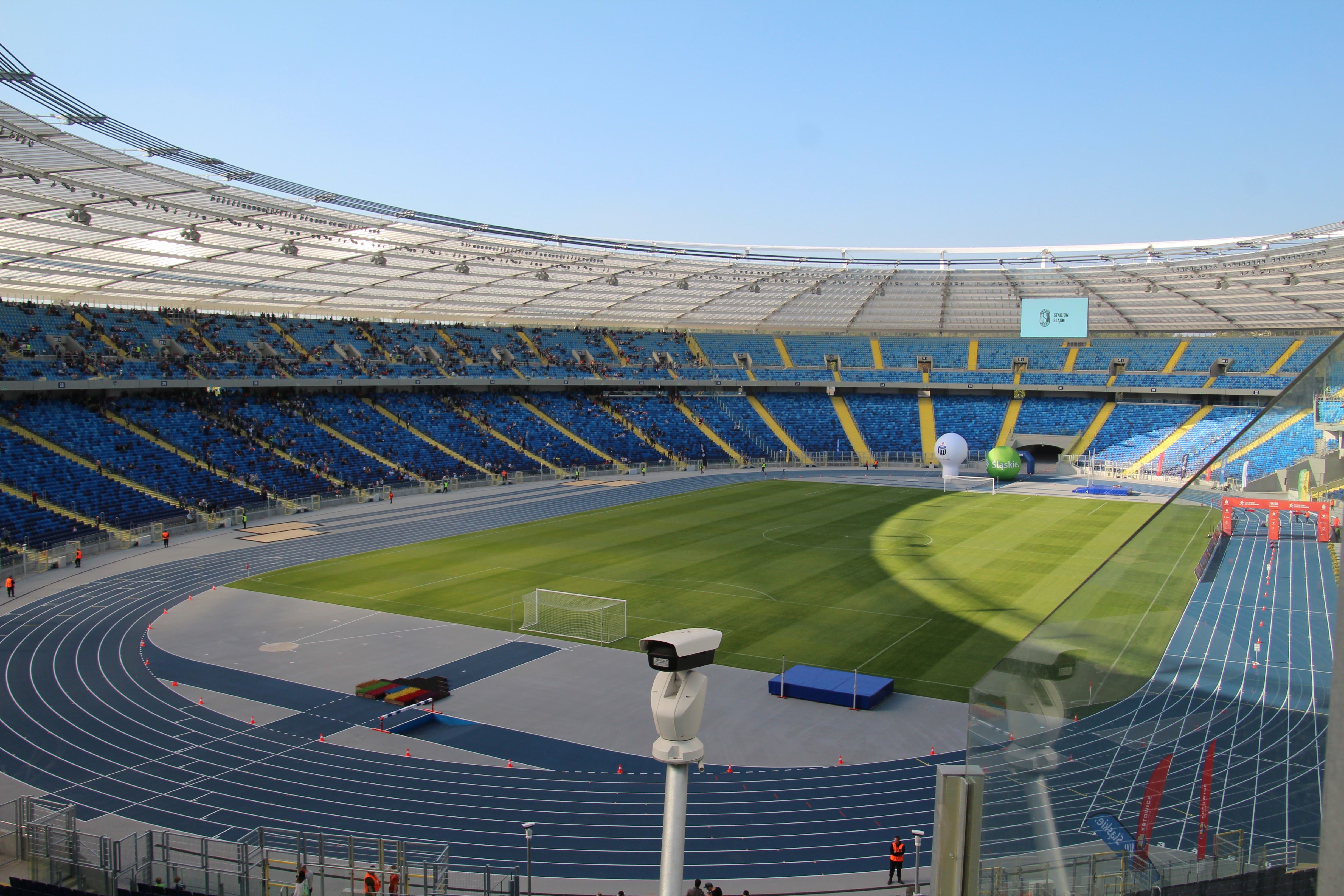 Stadium operators calibrating tracking cameras beneath bright World Cup floodlights