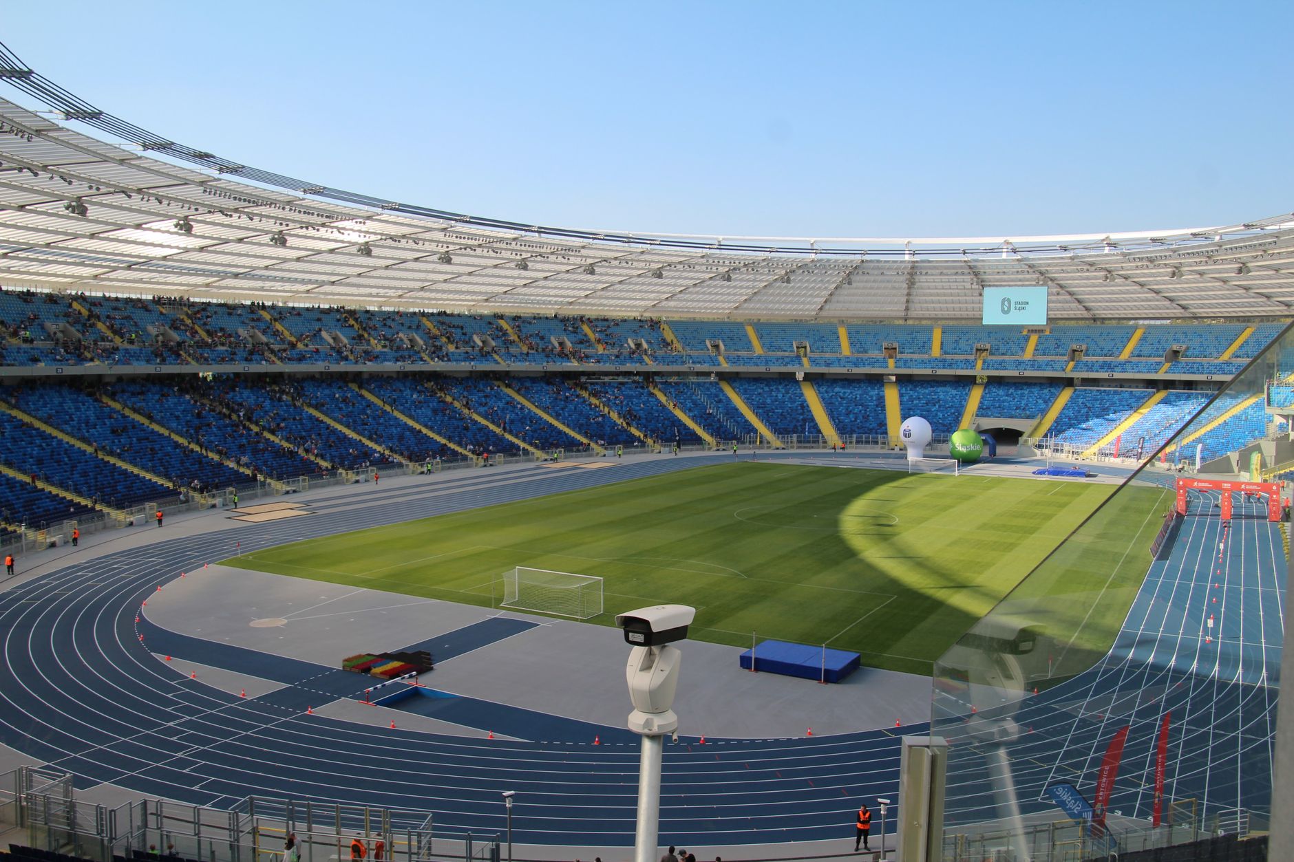 Stadium operators calibrating tracking cameras beneath bright World Cup floodlights