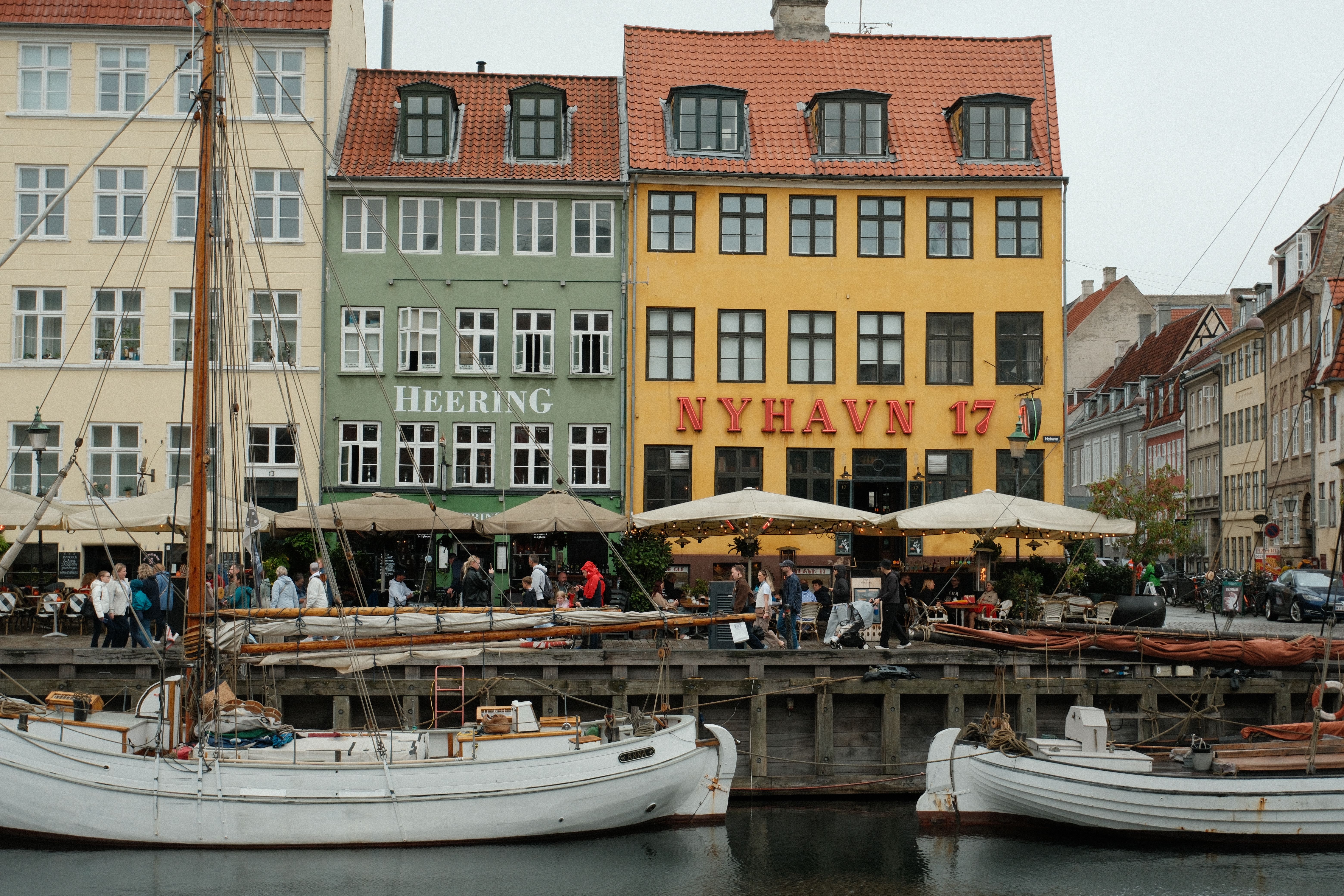 Colorful buildings and boats along the iconic Nyhavn canal in Copenhagen, Denmark.