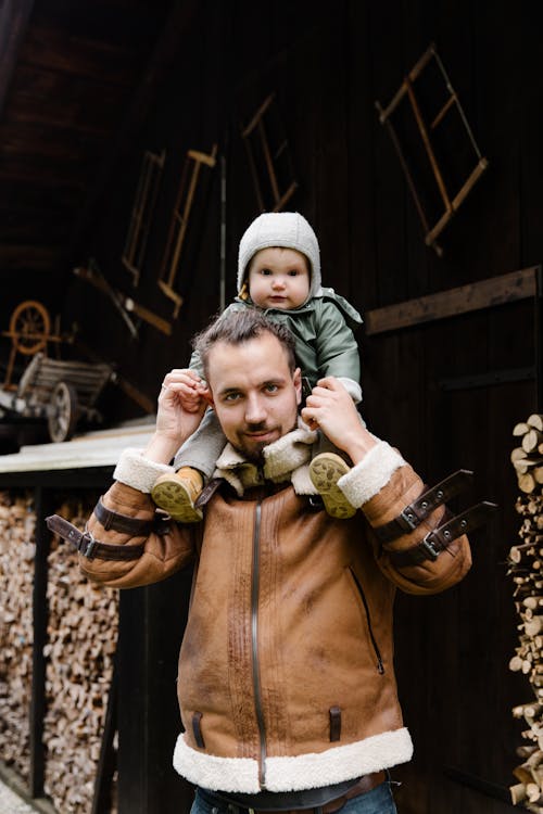 Man Carrying Child on His Shoulder