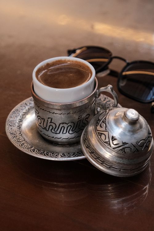Free Enjoy a traditional Turkish coffee served in an ornate metal cup with a decorative lid, symbolizing cultural richness. Stock Photo