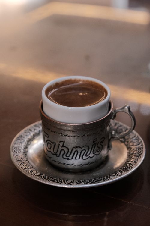 Free A close-up of rich Turkish coffee in an elaborately designed metallic cup and saucer. Stock Photo