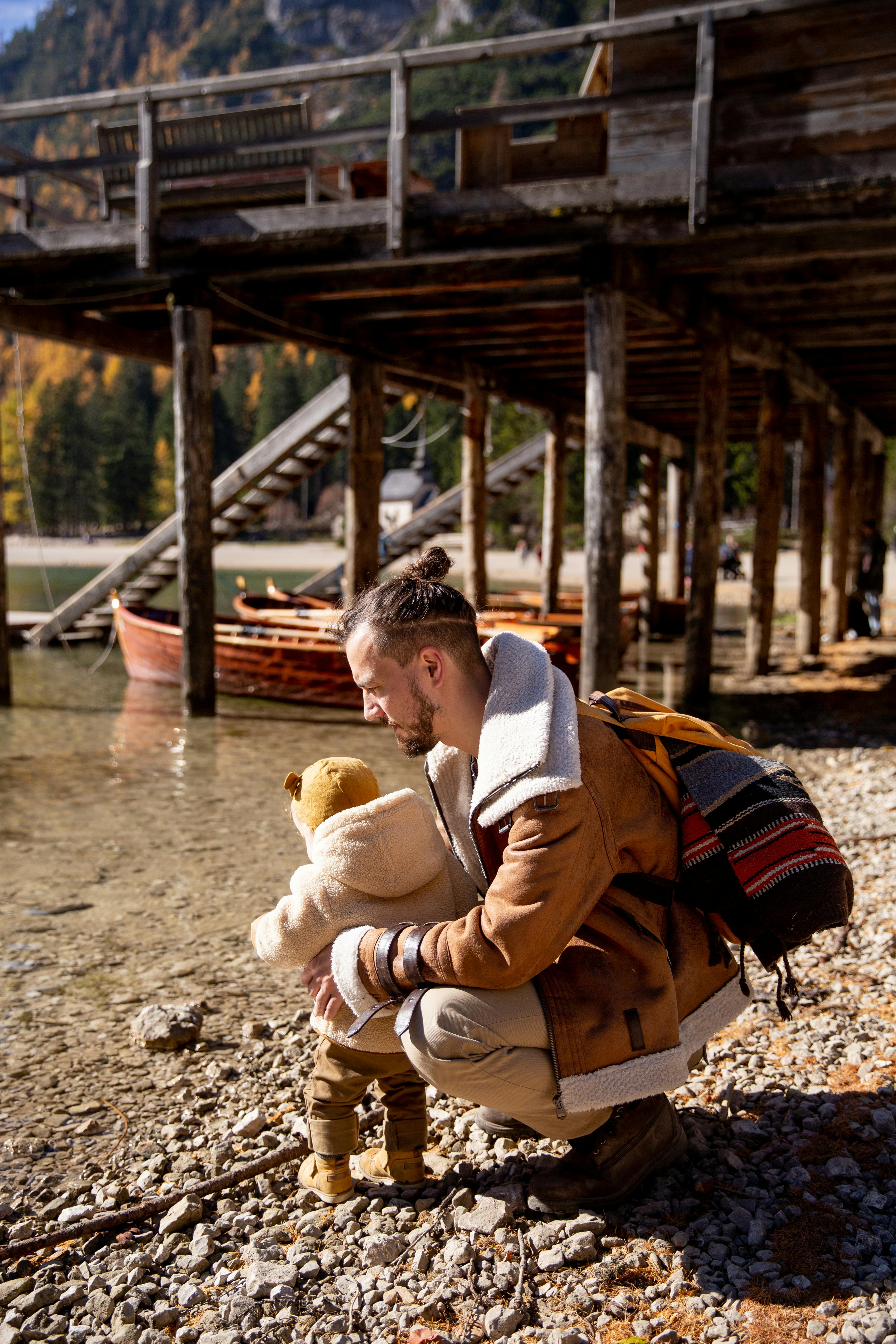 photo of man holding baby