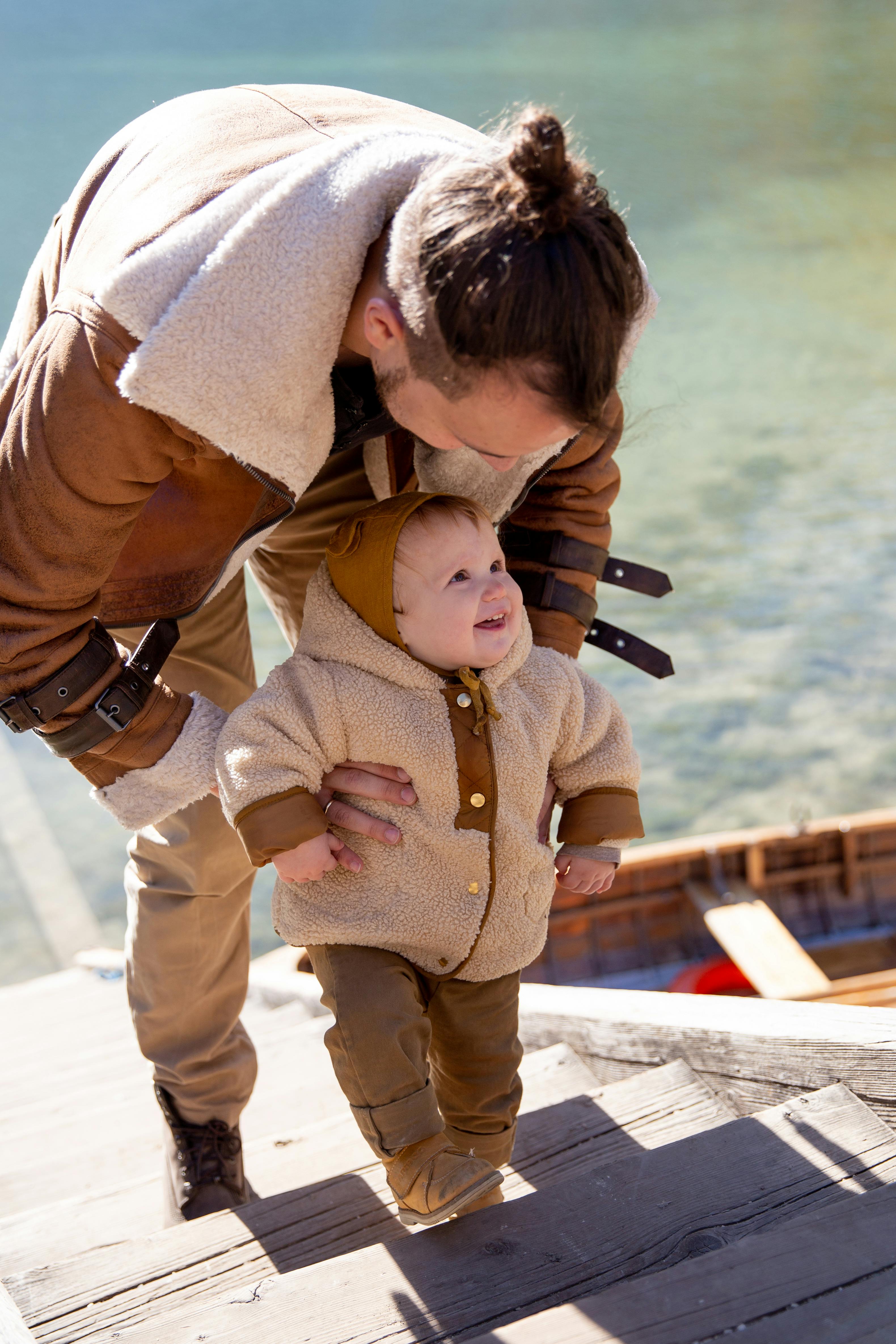 photo of man holding child