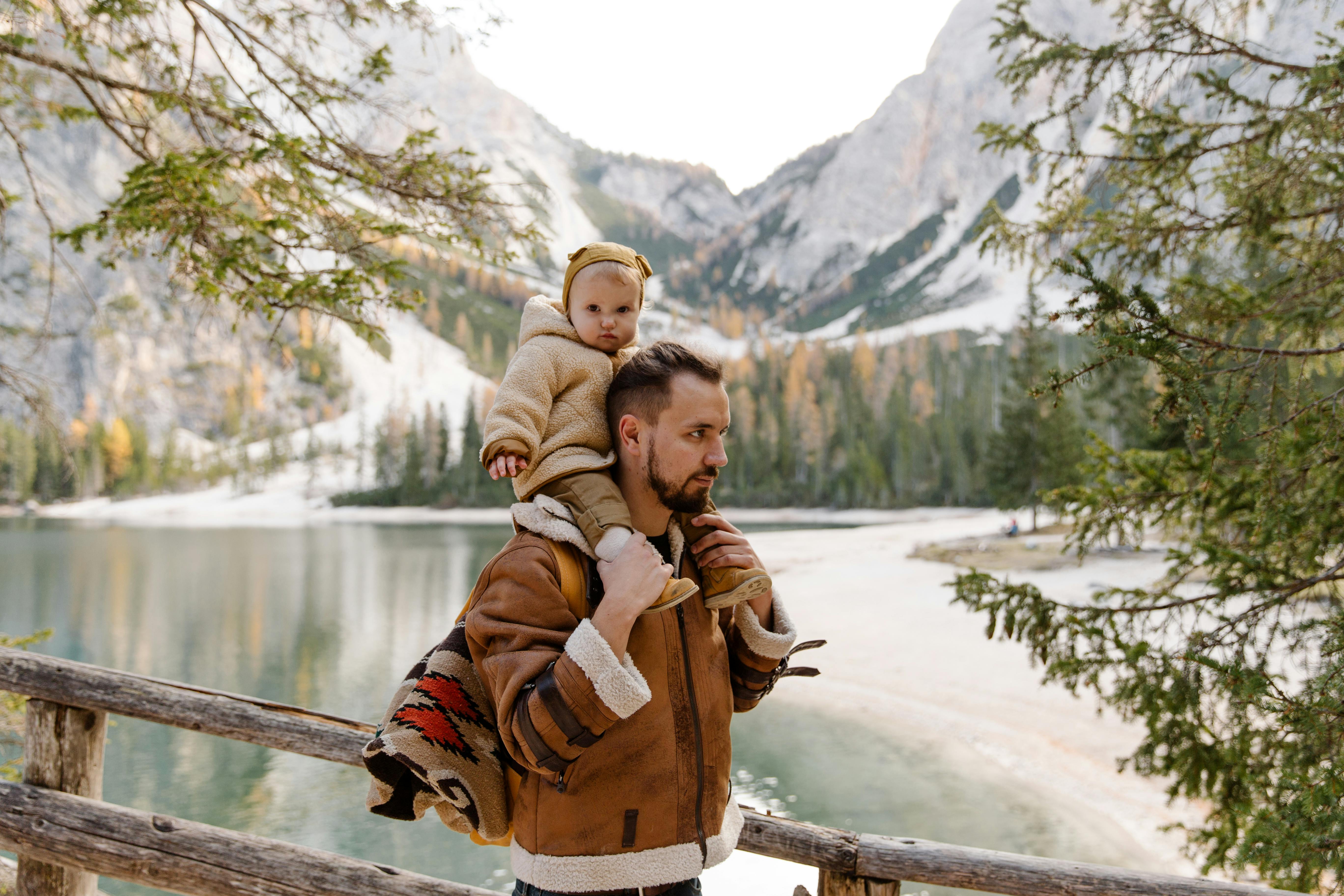 photo of man carrying child