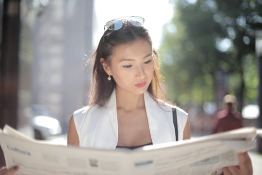 Woman Reading News Outdoors