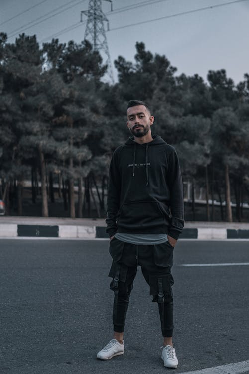 Man in Black Hoodie Standing on Road