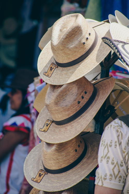 Free A vibrant display of traditional straw hats at a local market in Oaxaca, Mexico. Stock Photo