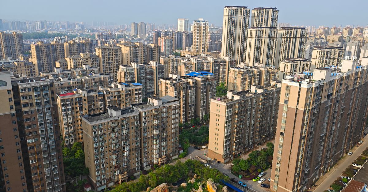 Aerial photograph showcasing the dense urban skyline of Changsha, China with high-rise buildings and lush greenery.