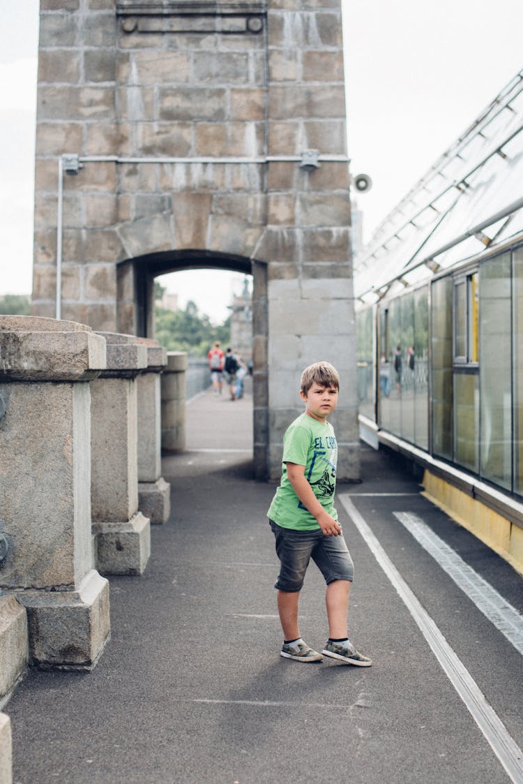 A Boy Walking On The Street