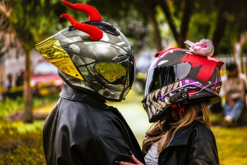 Free Creative photo of a couple in artistic helmets, showcasing a fun and colorful style outdoors. Stock Photo