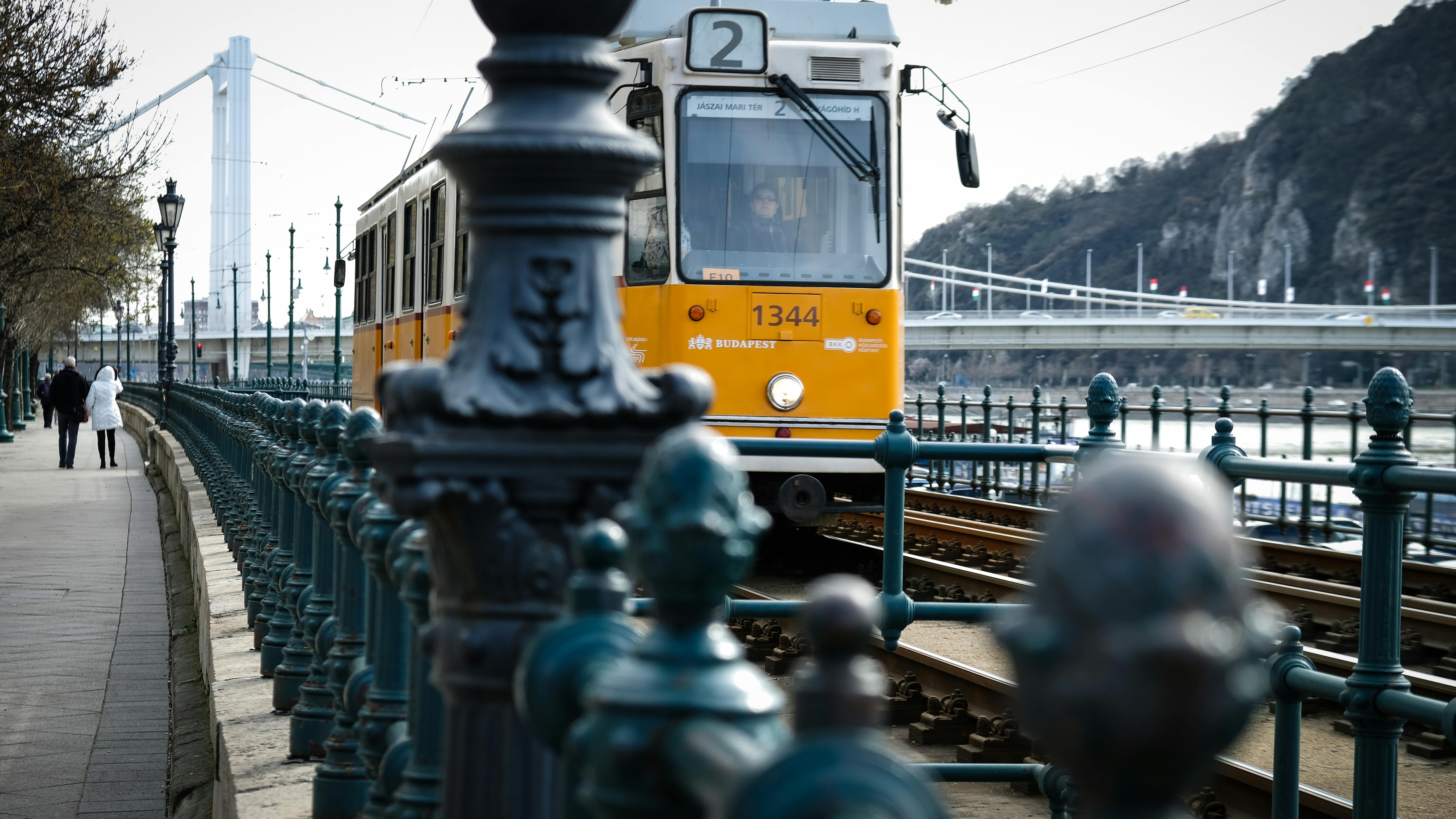 Free A tram travels along the Danube riverfront in Budapest, Hungary. Scenic urban transportation scene. Stock Photo