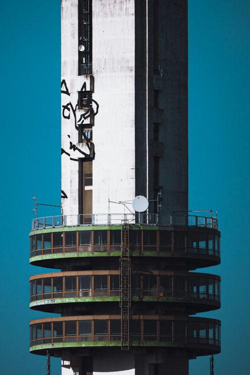 Free Close-up of a modern tower with observation deck set against a clear blue sky. Stock Photo