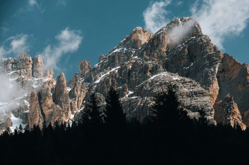 Free Capture of snow-covered peaks in the Dolomites under a clear blue sky, conveying natural beauty. Stock Photo