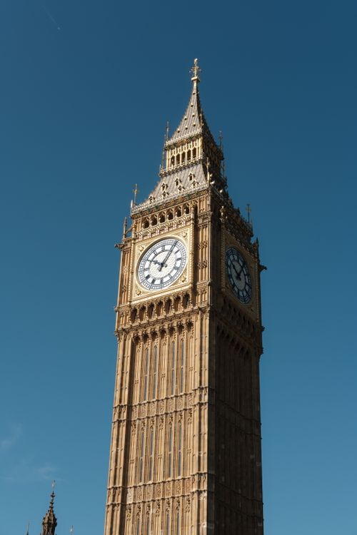 Free Stunning view of the Big Ben clock tower in London with a clear blue sky background. Stock Photo