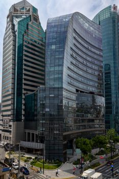 An impressive view of modern skyscrapers with reflective glass facades in a bustling urban environment.