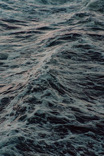From above of foamy wavy on water surface in stormy weather in nature in sundown tine in tropical lagoon in summer