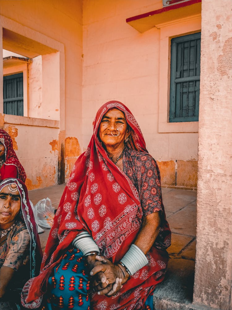 Old Indian Woman With Girl Sitting On Terrace