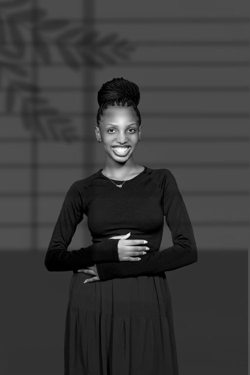Free Black and white portrait of a smiling woman with braided hair and black dress. Stock Photo