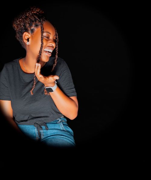 Free A joyful woman laughing in a dark studio, emphasizing happiness and positivity. Stock Photo