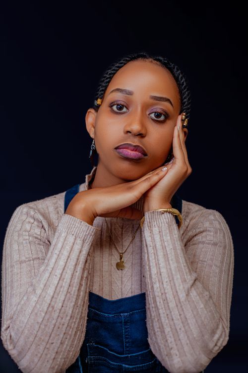 Free Elegant portrait of a woman with braided hair and serene expression. Stock Photo
