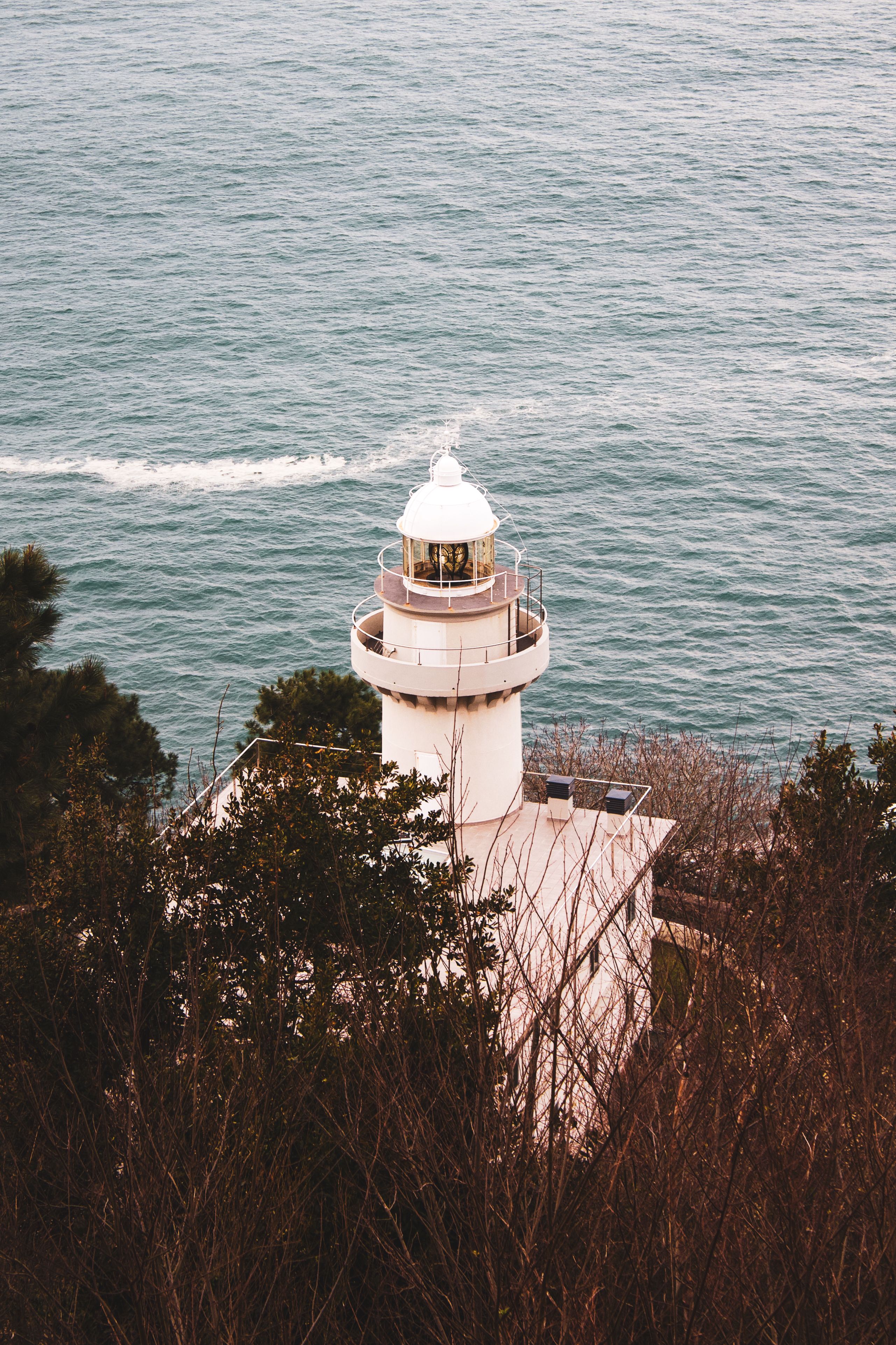 Photo Of Lighthouse Beside Sea · Free Stock Photo