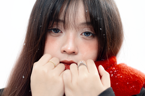 Free Close-up portrait of a young woman with red scarf and snowflakes in her hair. Stock Photo