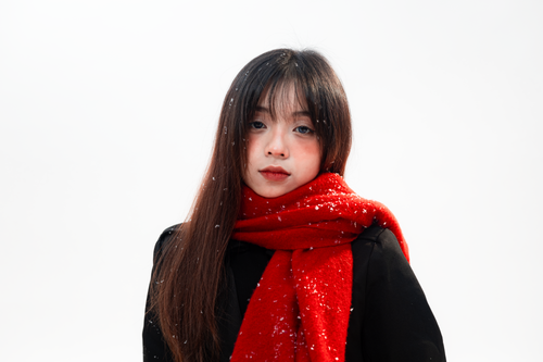 Free Woman with red scarf in winter setting, snowflakes in hair. Stock Photo